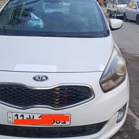 كيا كارينز 14 رقم بغداد باسمي ماشيه 135  كير ومحرك وتبريد مكفول حداديه...