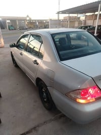 لانسر موديل 2004مصبوغه عام كير محرك كفاله عامه تدفئه تبريد كلها جاهزة ...