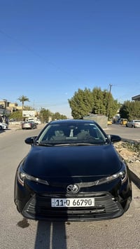 كورلا امريكي ٢٠٢٤  فئة LE مكينة 2.0L اسود شذرة زرگة رقم بغداد بأسمي تح...