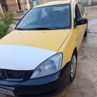 لانسر ٢٠١٠ • محرك وكير مكفول • رقم ديالى