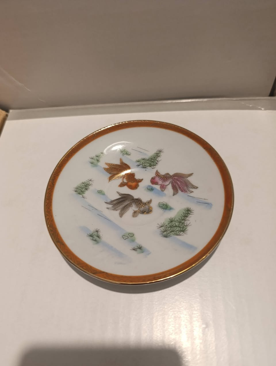 فناجين للبيع ياباني صنع 1930,بحالة ممتازة
العلامة الموجودة في أسفل الفنجان هي تقنية فنية يابانية تُعرف باسم "ليثوفين" (Lithophane).)

إليك أهم المعلومات حول هذه العلامة:
صورة محفورة بدقة داخل البورسلين الرقيق جداً (المعروف ببورسلين قشر البيض)، ولا تظهر بوضوح إلا عند تسليط الضوء من خلفها أو من أسفل الفنجان.

الشخصية المصورة: الصورة غالباً ما تمثل وجه امرأة يابانية تقليدية تُعرف باسم "غيشا" (Geisha).
الأصل والتاريخ: انتشرت هذه الفناجين في اليابان بشكل كبير خلال الفترة من أواخر القرن التاسع عشر وحتى منتصف القرن العشرين، وغالباً ما كانت تُصنع كقطع تذكارية للتصدير، خاصة في منطقة "كوتاني" (Kutani).
القيمة المعنوية: تعتبر هذه القطع اليوم من "الأنتيكات" التي يقدرها الهواة، حيث تعكس براعة الصناعة اليدوية اليابانية في تطويع البورسلين لإنشاء صور فنية مخفية.


**إذا كنت صاحب هذا الإعلان وتريد حذفه لأي سبب، رجاءا أرسل رسالة إلى الدعم الفني**