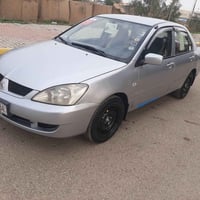 لانسر ٢٠٠٦ رقم بابل انكليزي بسمي مشروع وطني مكينة 1600 قبق اسود كير مك...