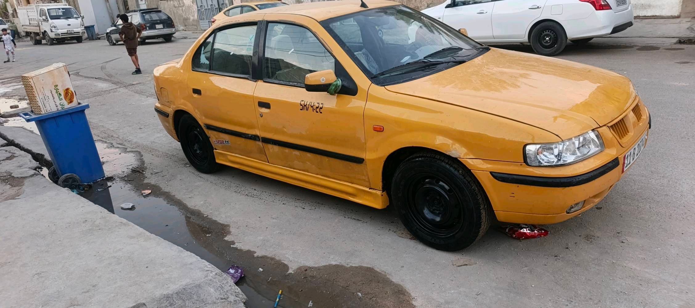 سيارة صالون صفراء، داخلية واسعة وعجلة قيادة مغطاة للراحة. الجنوط باللون الأسود لإضافة لمسة من الأناقة. السيارة مناسبة للاستخدام اليومي. موثوقة للأسر والجولات داخل المدينة.