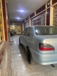 بيجو موديل 2001مصبوغة عام جمالية كير ومكينة بالجيس رقم بغداد صدامي ماا...