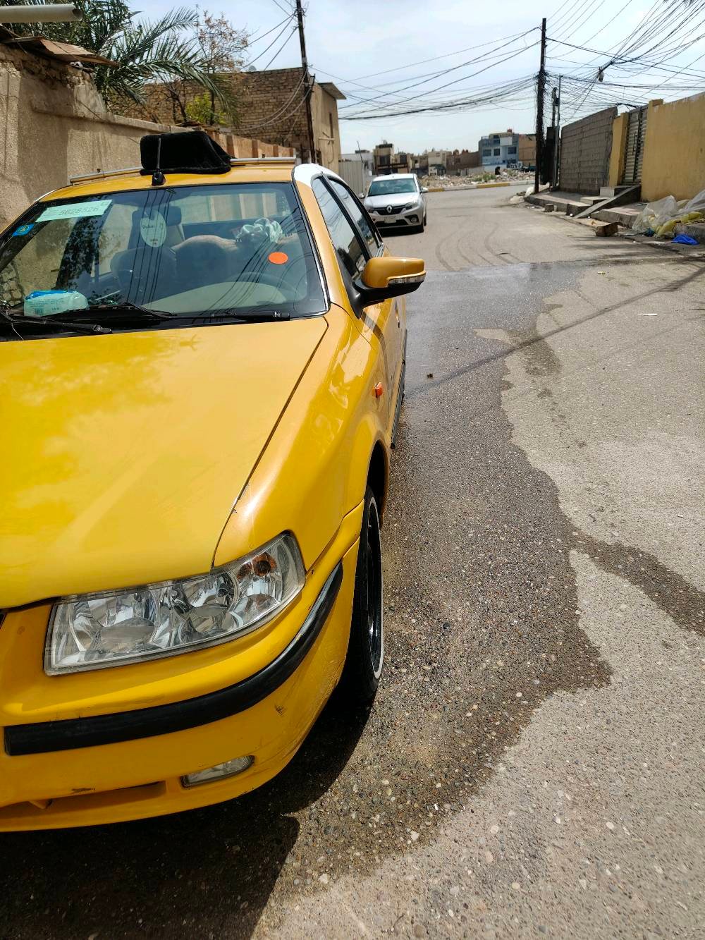 سيارة تاكسي صفراء معروضة للبيع، بحالة جيدة ومستعدة للعمل مباشرة. جسم السيارة نظيف ومصبوغ باللون الأصفر اللامع لتكون مرئية وواضحة في الشوارع.
