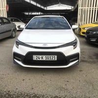 كورلا 2021 SE الون ابيض ماشه 59 الف حقيقي  سيارة فول عدا فتحه بصمة كشن...