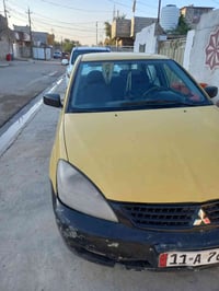 لانسر وارد أمريكي ظربتهه خلفيه   موديل ٢٠٠٩  كير اوتو   رقم بغداد  مكا...