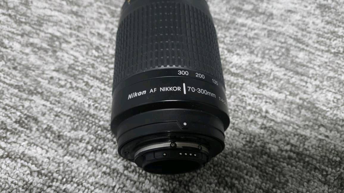زوم رياضي 70-300
نيكون من شركة نيكور
يرهم لكامرات نيكون الفئات المتوسطة
فئة ال7000 الى 7600 ونيكون 610
والكثير من الكامرات بمثل هذه المواصفات 
بلمختصر المفيد ترهم على الكامرات الي تحتوي
على نضام AF فقط
.
مواصفات العدسة ""
البعد البؤري (Focal Length): من 70mm إلى 300mm (عدسة زوم وتقريب ممتازة لالتقاط الأشياء البعيدة، والطيور، والرياضة، وحتى البورتريه).نوع العدسة: G-type (تتحكم بفتحة العدسة من خلال جسم الكاميرا نفسه، ولا تحتوي على حلقة ميكانيكية خارجية للفتحة).f/4 عند البعد البؤري 70mm
f/5.6 عند البعد البؤري 
300mm
.
للاستفسار اكثر ***********
وضروري تنطينـي اسـم كامرتــك