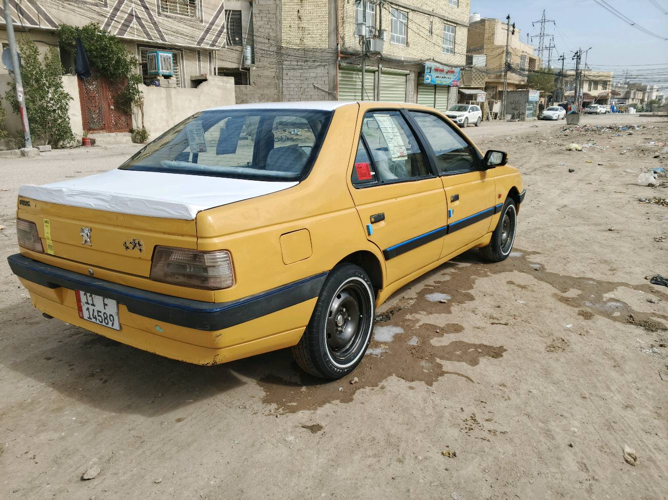 السيارة المعروضة للبيع هي بيجو بلون أصفر مع إكسسوارات زرقاء وسقف أبيض مميز. المقاعد مُغطاة بواقٍ بلاستيكي للحفاظ على النظافة، والمقود مُغطى بتغليف لضمان حماية إضافية. السيارة تبدو في حالة جيدة ولا توجد أضرار ظاهرة في الهيكل الخارجي أو الداخلي. الصندوق الخلفي واسع وكافٍ لحمل الأغراض. هذه السيارة مثالية للاستخدام اليومي أو للأعمال بفضل حالتها المحافظة والتجهيزات الأساسية المتوفرة فيها.