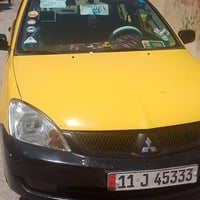 لانسر موديل 2010مصفره من كلشي صدر كير محرك كفاله كير اوتو محرك 2000بيه...