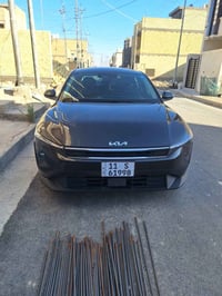 (كيا K4 2025 EX)رقم بغداد مميز  بأسمي و صور الحادث مرفقة مع صور  بدون ...