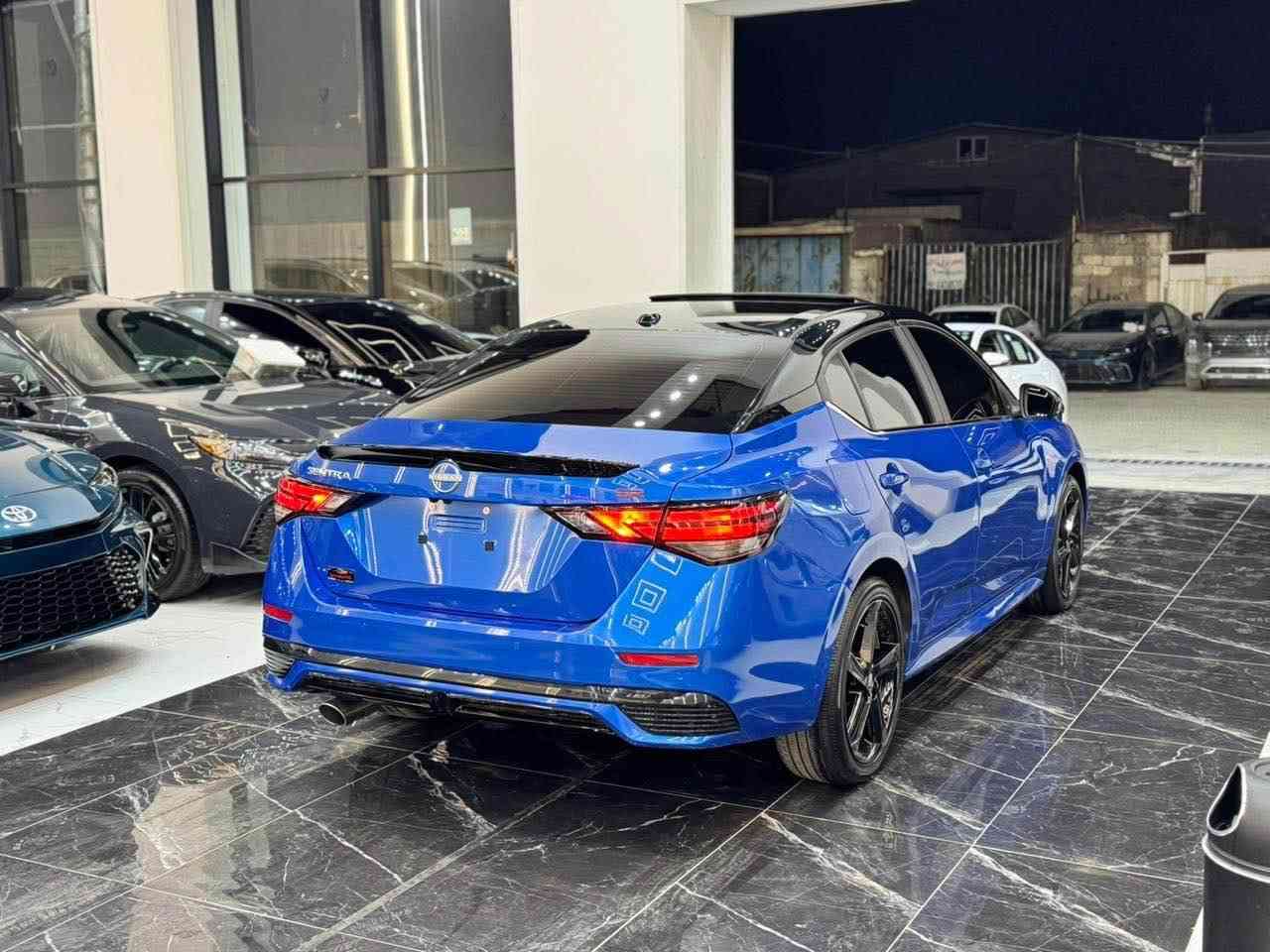 𝟐𝟎𝟐𝟒 𝐍𝐈𝐒𝐒𝐀𝐍 𝐒𝐍𝐓𝐑𝐀-𝐒𝐑.𝐏𝐋𝐔𝐒

نيسان سنترا (𝐒𝐑.𝐏𝐋𝐔𝐒) موديل : 2024

اللون :ازرق مميز سقف اسود بيلادي

عداد المسافة : 674 زيـــرو

حجم المحرك : 2.0L (4.سلندر)

ملاحظة السيارة : فقط ربع جاملغ صبغ بدون دواخل 

كافة الايرباكات سليمة 100%

المواصفات : 𝐒𝐑.𝐏𝐋𝐔𝐒

فول فول مواصفات 1/1

فتحة سقف سلايد 
 بصمة ابواب 
بصمة تشغيل 
تشغيل عن بعد (𝐑𝐄𝐌𝐎𝐓𝐄 𝐒𝐓𝐀𝐑𝐓)
سستم سماعات 🔊 (𝐁𝐎𝐒𝐄)
شاشة دشبول ديجيتال
شحن وايرليس
كاميرا °360
‏‎كاميرا امامي
كاميرا جانبي
كاميرا خلفي
اوتو ستارات (𝐀𝐔𝐓𝐎 𝐒𝐓𝐀𝐑𝐓)
اوتو ستوب (𝐀𝐔𝐓𝐎 𝐒𝐓𝐎𝐏)
رادار امامي (تحديد مسار)
رادار جانبي  (نقاط عمياء)
رادار خلفي (التحذير من الاصطدام)
حساسات امامي
حساسات جانبي 
حساسات خلفي 
نظام (𝐄𝐂𝐎)
نظام (𝐍𝐎𝐑𝐌𝐀𝐋)
نظام (𝐒𝐏𝐎𝐑𝐓)
كشنات جلد
كشنات كهربائي
كشنات هيتر
تحكمات استيرن
استيرن هيتر
تبريد لمس 
تبريد مركزي 
لايتات ليـــLEDـــد عدسة زينون بيلادي
بكلايتات ايـــLEDـــد بيلادي
ويــــل كــــروم  

بعد هواية مواصفات…

‏‎تفاصيل اكثر الاتصال علی ارقام التاليه ‏

☎️***********

☎️***********

‏‎عنوان📍اربيل فرع ناقلات

معرض كاليفورنيا كارس CALIFORNIA Cars أربيل, العراق
