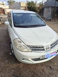 نيسان تيدا 2009 رقم انكليزي بيها  تبديل باب السايق و جامرلغ جهة السايق...