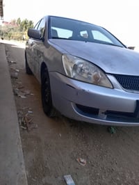 لانسر مسبوشي موديل 2010  كير محرك مكفول  تبريد ثلج وتدفئه هم + شاشه بل...