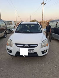 سبورتاج ٢٠٠٩ • ابيض • كشنات جلد