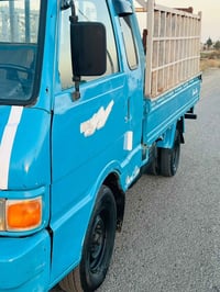 كيا بنجو ٩٦ • رمادي الأنبار • مكفولة