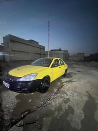 لانسر 2010  شركه مكينه 2000 كير عادي رقم بغداد بسمي سنويا 27 مكاني بغد...