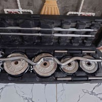 تجهيزه حديد كامله متكونه من دمبلص اثنين  بار طويل بار w 55 كيلو  150 0...