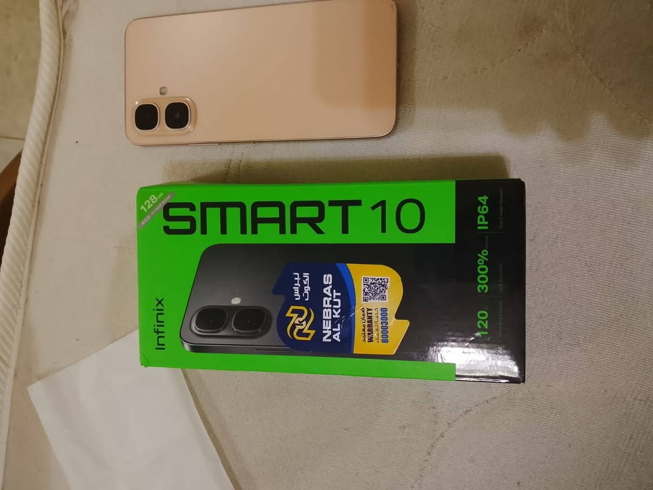 يظهر أنه Infinix Smart 10 إصدار 128 جيجابايت.
إليك أبرز مواصفاته:
الشاشة: 6.67 بوصة IPS LCD بدقة HD+ (720×1600).
معدل التحديث: حتى 120Hz لسلاسة أفضل في التصفح والألعاب. �
Infinix Mobiles
المعالج: Unisoc T7250 ثماني النواة.
الذاكرة: 4 جيجابايت RAM (مع دعم توسيع الذاكرة افتراضيًا) + 128 جيجابايت تخزين داخلي. �
Infinix Mobiles +١
الكاميرا الخلفية: 8 ميجابكسل.
الكاميرا الأمامية: 8 ميجابكسل.
البطارية: 5000mAh.
الشحن: 15 واط عبر منفذ USB-C.
النظام: Android 15 مع واجهة XOS 15.1.
الصوت: سماعتان ستيريو مع رفع مستوى الصوت حتى 300% (كما هو مذكور على العلبة).
الحماية: مقاومة الغبار ورذاذ الماء بمعيار IP64.
ميزات إضافية: بصمة جانبية، منفذ سماعات 3.5 مم، منفذ microSD لتوسعة التخزين حتى 2 تيرابايت، ودعم الأشعة تحت الحمراء (IR). �
Infinix Mobiles
السعر 165 مستخدم يظهر أنه Infinix Smart 10 إصدار 128 جيجابايت.
إليك أبرز مواصفاته:
الشاشة: 6.67 بوصة IPS LCD بدقة HD+ (720×1600).
معدل التحديث: حتى 120Hz لسلاسة أفضل في التصفح والألعاب. �
Infinix Mobiles
المعالج: Unisoc T7250 ثماني النواة.
الذاكرة: 4 جيجابايت RAM (مع دعم توسيع الذاكرة افتراضيًا) + 128 جيجابايت تخزين داخلي. �
Infinix Mobiles +١
الكاميرا الخلفية: 8 ميجابكسل.
الكاميرا الأمامية: 8 ميجابكسل.
البطارية: 5000mAh.
الشحن: 15 واط عبر منفذ USB-C.
النظام: Android 15 مع واجهة XOS 15.1.
الصوت: سماعتان ستيريو مع رفع مستوى الصوت حتى 300% (كما هو مذكور على العلبة).
الحماية: مقاومة الغبار ورذاذ الماء بمعيار IP64.
ميزات إضافية: بصمة جانبية، منفذ سماعات 3.5 مم، منفذ microSD لتوسعة التخزين حتى 2 تيرابايت، ودعم الأشعة تحت الحمراء (IR). �
Infinix Mobiles
السعر 165 مستخدم شهر واحد فقط 
مكاني واسط كوت الفلاحية  رقم الهاتف***********
