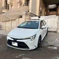 كورلا هايبرد شكل امريكي  ماشيه 15 الف فقط بعدها بحالة الوكاله رقم بغدا...