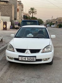 عندي لانسر بيضاء موديل 2006 رقم بغداد انكليزي هزه وسنويه وأرقام جدد با...