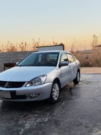 لانسر موديل 2010 ديالى مشروع وطني  مكفولة عدى قطعتين صبغ اثر كلير كير ...