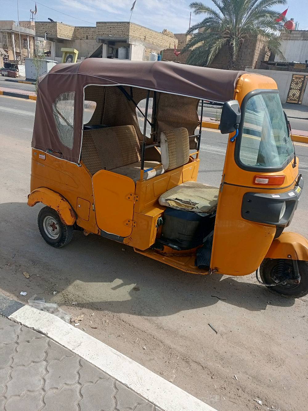 هذا التكتك متين ولونه برتقالي، مثالي للتنقل داخل المدينة وتحمل الأحمال الخفيفة. تصميمه عملي جداً ويشمل سقفًا للحماية من الشمس والمطر. هيكله يحتاج لبعض الإصلاحات السطحية ولكن التحكم به سهل ومريح. مناسب للاستخدام الشخصي أو كوسيلة نقل.