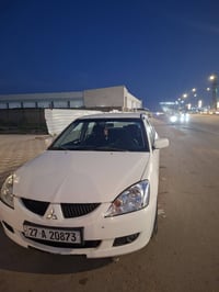 لانسر موديل 2006 رقم دولي بسمي  السياره مكفوله  وجاهزه مكينة كير تبريد...