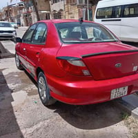 كيا ريو 2001 امريكي بأسمي السياره جاهزه مكانها بغداد  ب45 صبغ احزام077...
