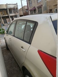 نيسان تيدا 2006 رقم بغداد گير ومكينة مكفولات مكينه 1600 بيه قطعتين صبغ...