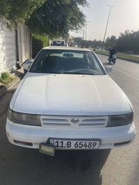 نيسان مكزما 89 بلادية بدون حادث لون ابيض فتحه بالسقف رقم دولي الجديد ش...