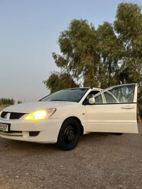 لانسر ٢٠٠٩ • بغداد باسمي • رقم مميز