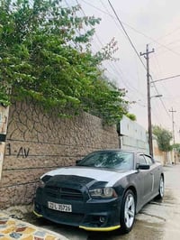 عندي سياره دوج   جارجر 2013 محرك وكير واكسن وطخم شرط جديد بيها تلث قطع...