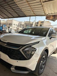للبيع.. كيا سبورتج امريكي هايبرد ابيض صدفي  موديل 2023  رقم بغداد بـ ا...