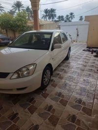 لانسر ٢٠١٠ • ١١٥ الف • اوتوماتيك