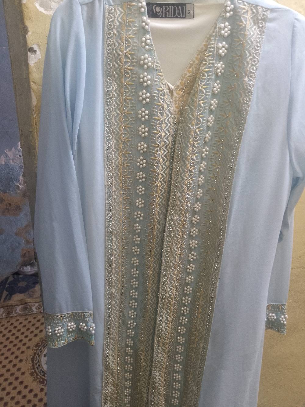 عباية أنيقة باللون السماوي مع تطريز فاخر وخرز لامع. العباية مناسبة للمناسبات الخاصة وتضيف لمسة من الفخامة لمظهرك. موجودة بحالة ممتازة بدون عيوب. فرصة لا تفوتها إذا كنت تودين إضافة قطعة مميزة إلى خزانتك.