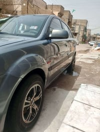 كيا ريو موديل 2006 وارد امريكي رقم بغداد انكليزي بسمي مكينة 1600 كير و...
