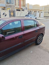 وبركاته  اوبل استرا 2002 رقم بغداد انكليزي بسمي سيارة 🚗 جاهزه مكفوله ص...