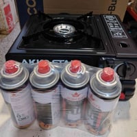 طباخ سفري + 4 قناني غاز +توصيل  ٢٠٠٠٠ الف 07716808597 07716808597