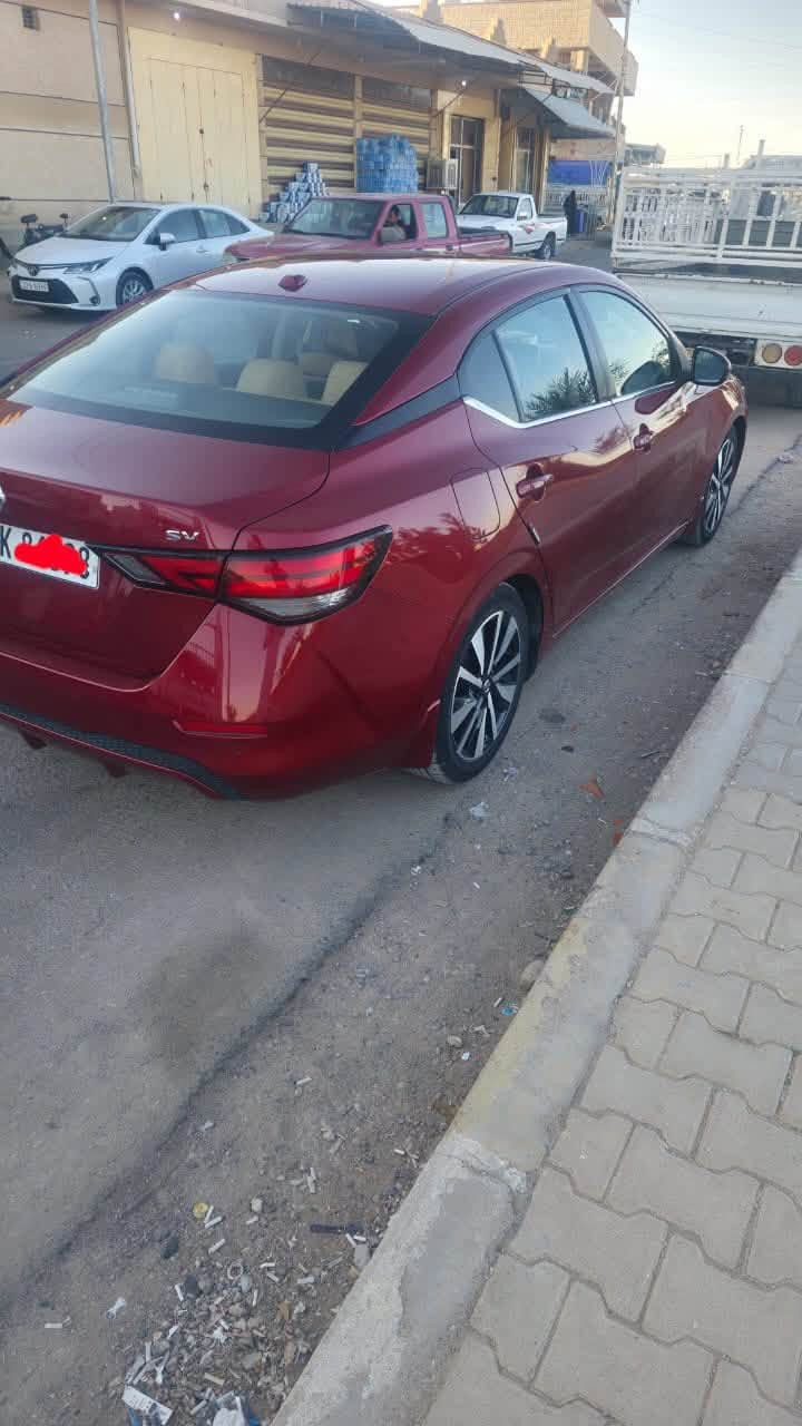 🚗 نيسان سنترا 2021 - SV (رقم اربيل  فول مواصفات)
اللون: ماروني
المحرك: 4 سلندر بسعة 2.0 لتر
كير: أوتوماتيك CVT
​فتحة سقف
​ تشغيل عن بعد + بصمة أبواب (دخول ذكي).
​رادار أمامي / مانع اصطدام مع فرملة طوارئ تلقائية.
 كشف النقطة العمياء 
​ تحديد وتنبيه الخروج عن المسار.
​رادار خلفي / فرملة طوارئ عند الرجوع للخلف.
​تثبيت سرعة ذكي  (Adaptive Cruise Control).
​شاشة لمس كبيرة تدعم Apple CarPlay و Android Auto.
​كاميرا خلفية دوارة
​تكييف مع تحكم مستقل السايق والراكب
​كوشن جلد كهربائي  تدفئة للمقاعد 
​ تحكمات ستيرن
​ويل كب ألمنيوم حجم 17./***********/بس شراي يدخل بله زحمه خوان رقمي بي واتساب
