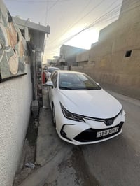 كورلا2024  شكل الخليجي محرك 1800 هايبرد HEV  داخل جلد أحمر رقم بغداد ب...