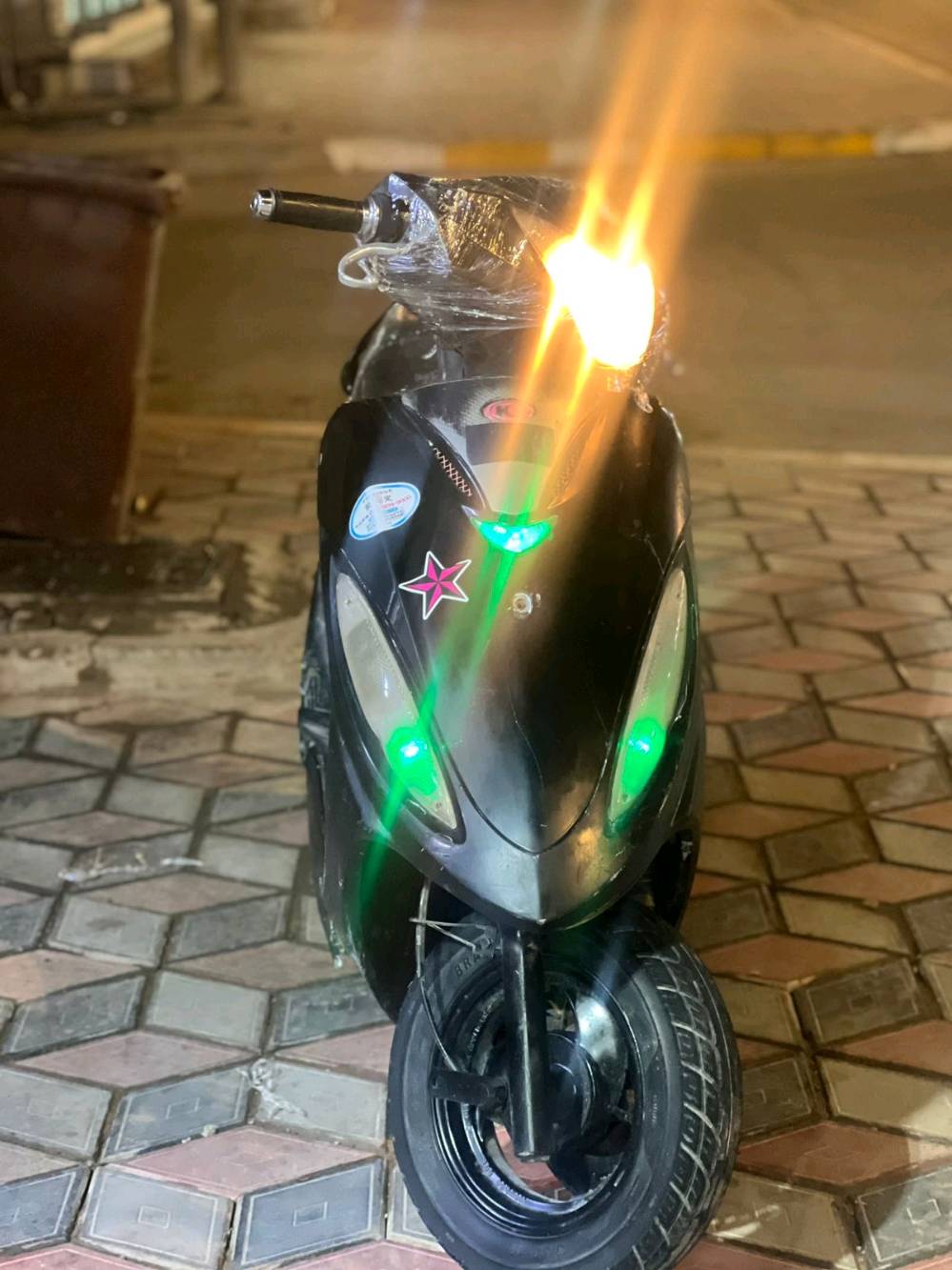 دراجة سكوتر مريحة وسهلة الاستخدام، مثالية للتنقل داخل المدينة. تتميز باللون الأسود وهي مزينة بملصقات مميزة. الإضاءة الأمامية والخلفية بحالة ممتازة، وبها عداد سرعة واضح.
