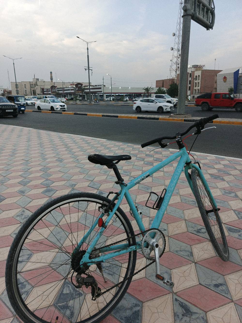بايسكل رياضي معاصر ولونه أزرق فاتح، في حالة جيدة ومناسب للرحلات اليومية. يتضمن مقعد مريح ومقود سهل التحكم. مثالي للياقة البدنية أو التنقل السريع داخل المدينة. تصميمه عملي ومناسب لجميع الأعمار.