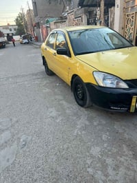 لانسر موديل 2010 صفرة بغداد ب اسمي تحويل ثاني يوم   كير عادي جديد مكين...