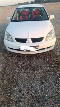 لانسر موديل 2011 كاملة اي نقص مابيه لاضربة ولاصبغ  رقم بغداد دولي بأسم...