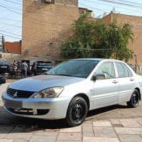 لانسر 2010 للبيع محرك 1500 رقم كربلاء الأنگليزي مكانها بغداد  ماشية 17...