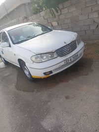 نيسان سني 2003ابلادي مامحور مصبوغه جماليه لاضربه ولاكصه رقم بغداد السع...