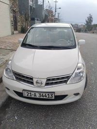 نيسان تيدا • أبيض لؤلؤي • رخصة لحد ٢٠٢٨