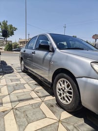 لانسر للبيع موديل 2005 مكينة 2000 مكفول كير مكفول تبريد شغال ثلج تخم ت...