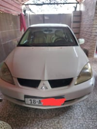 لانسر للبيع شركة العامه رقم بابل بيها قطعه واحده في جاملغ خلفي جهة سائ...
